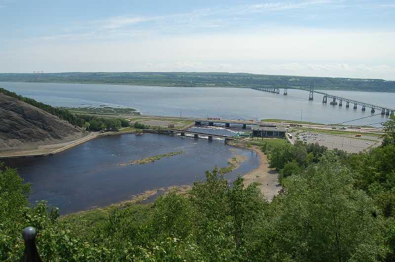 Canada East Tour 2006081.JPG - The fall's water flows into the St. Lawrence River.  The land in the picture background is Ile d'Orleans.